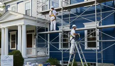 Painting contractors in Warwick, RI preparing a home exterior for painting